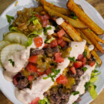 Animal Style Venison Burger Bowls with ground venison, crispy fires, caramelized onions, diced tomatoes and pickles.